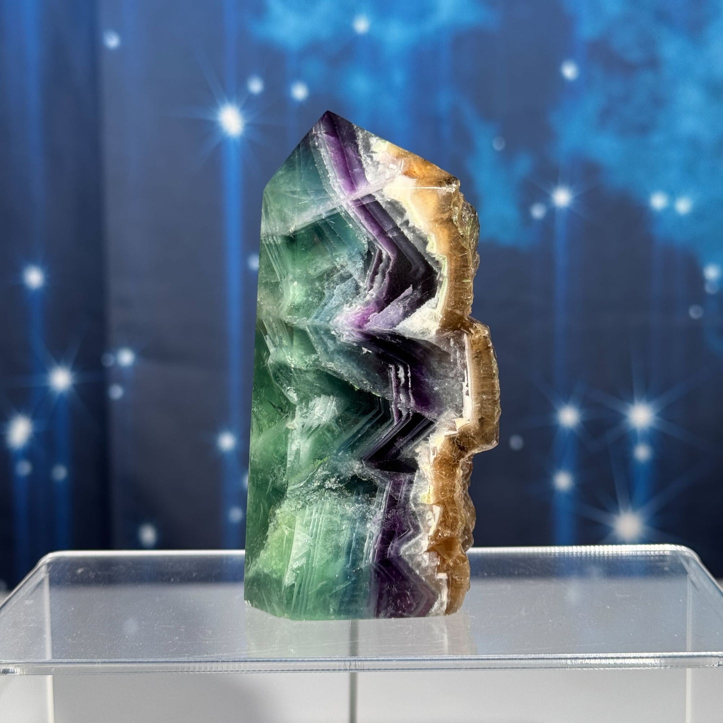 Rainbow Fluorite point with raw half