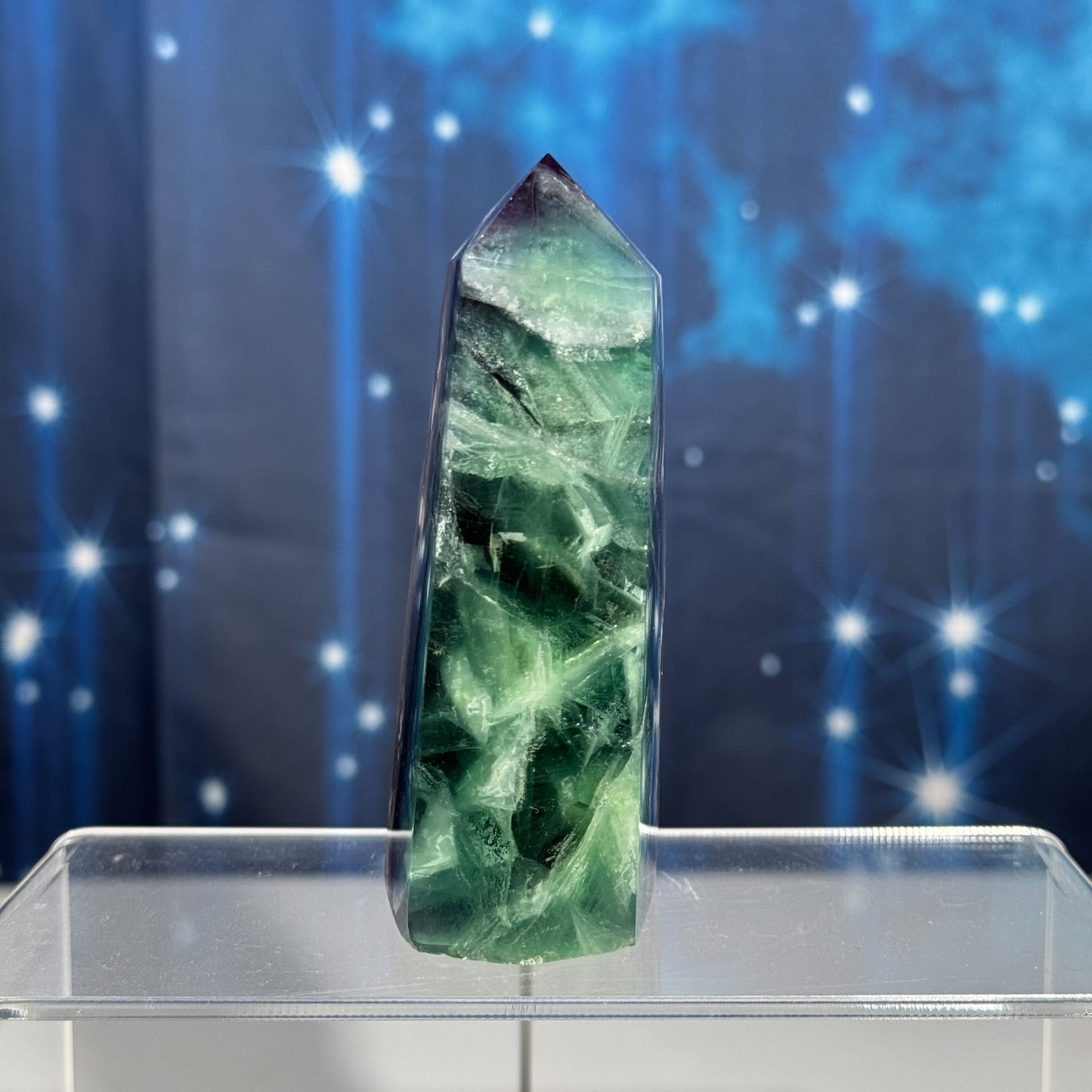 Rainbow Fluorite point with raw half