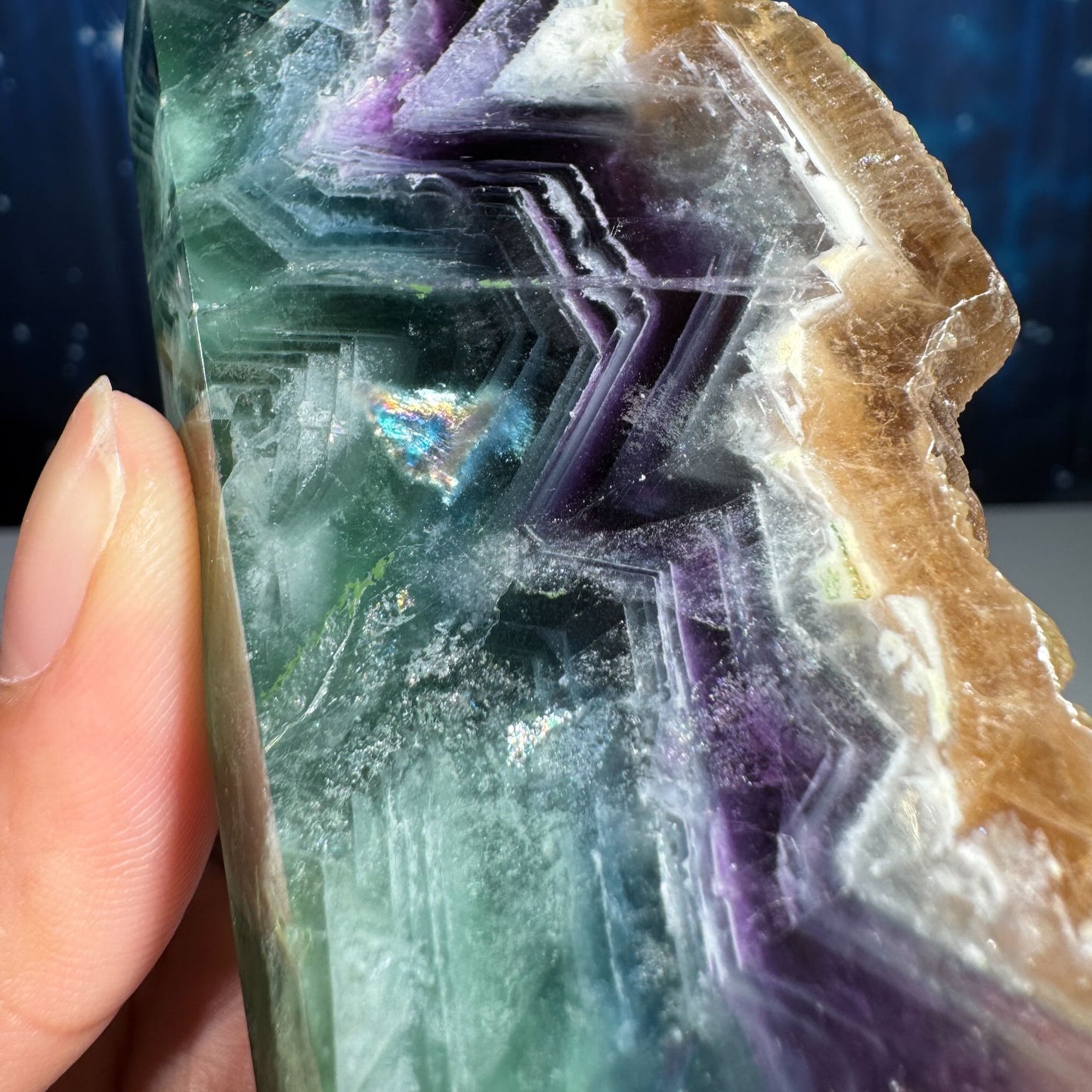 Rainbow Fluorite point with raw half