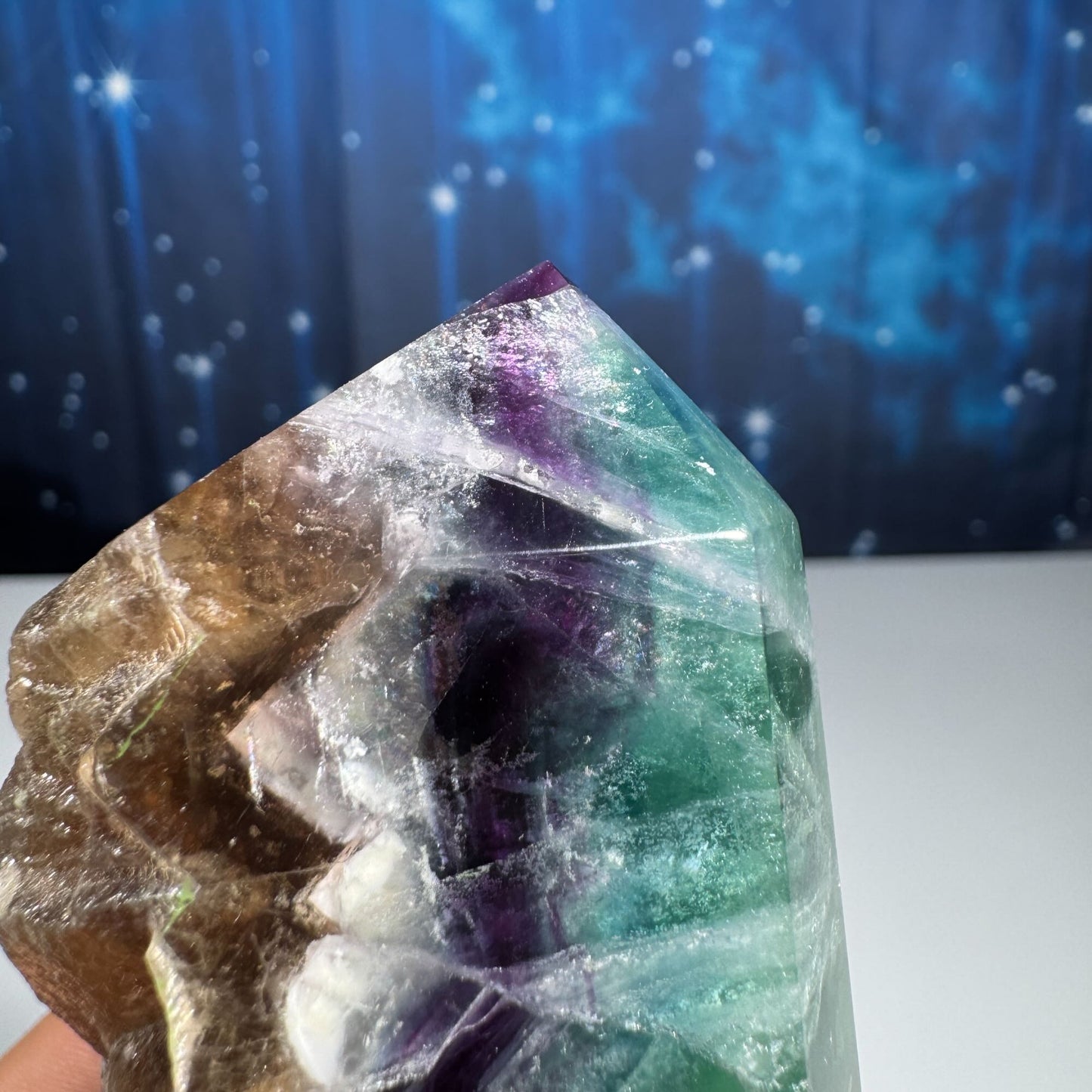 Rainbow Fluorite point with raw half