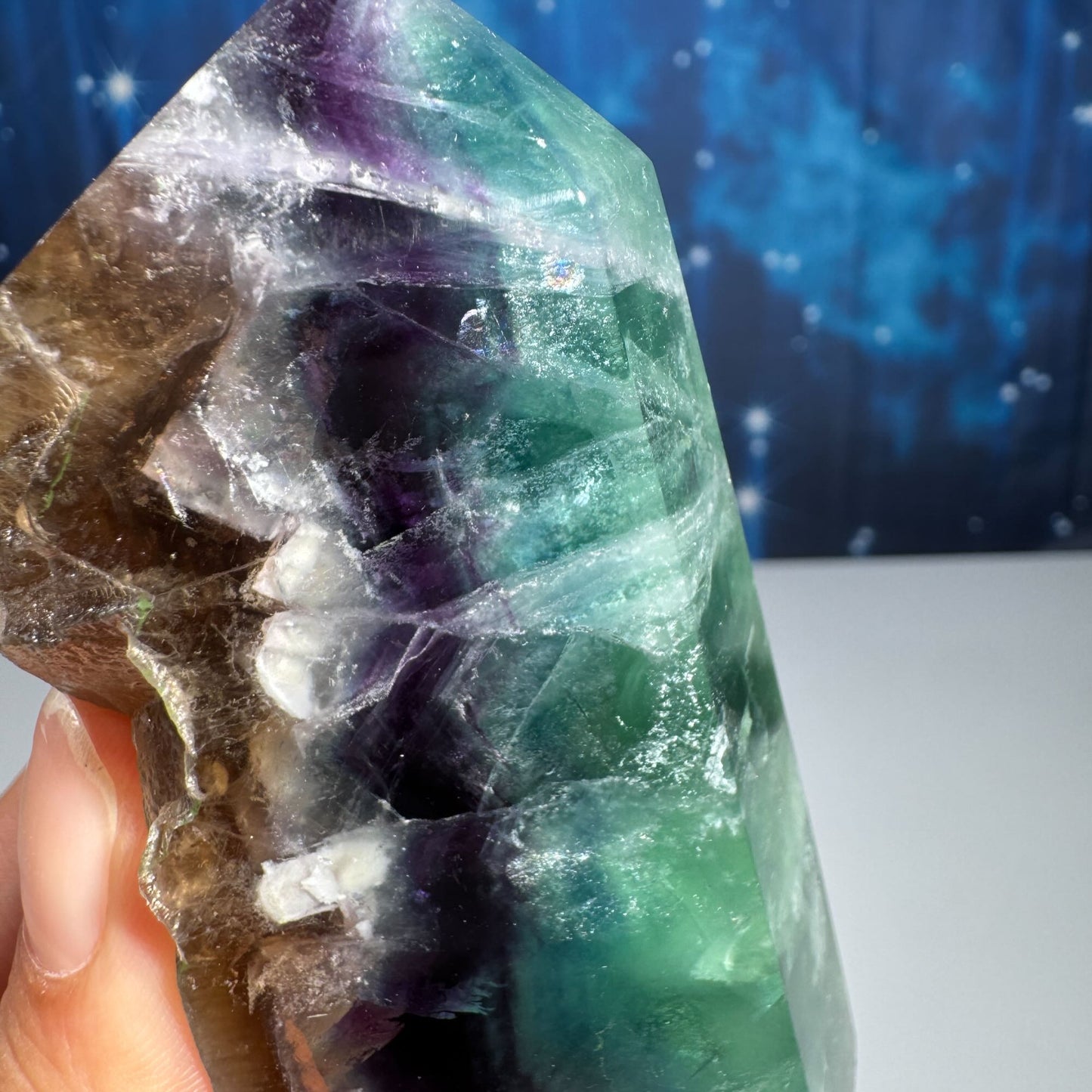 Rainbow Fluorite point with raw half