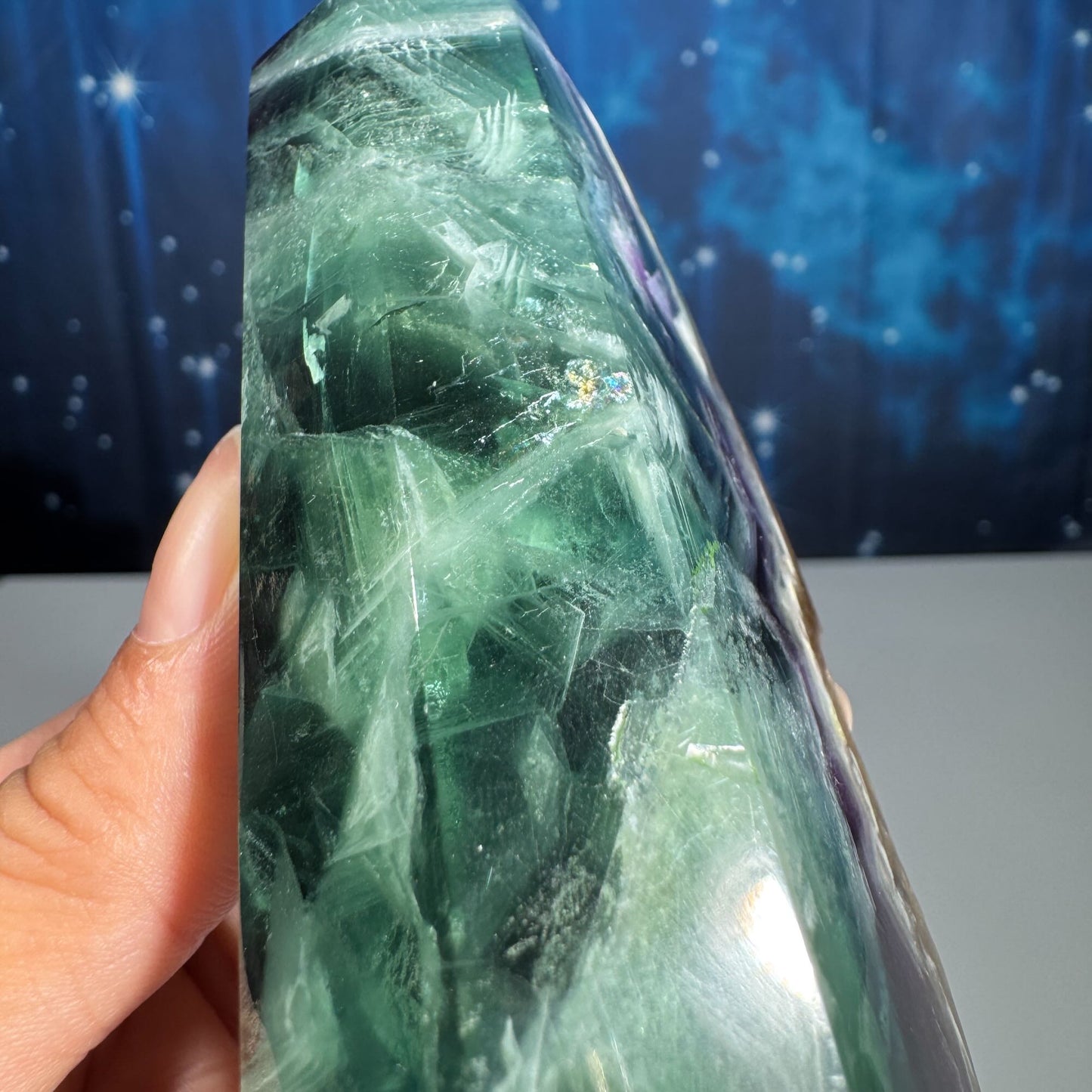 Rainbow Fluorite point with raw half