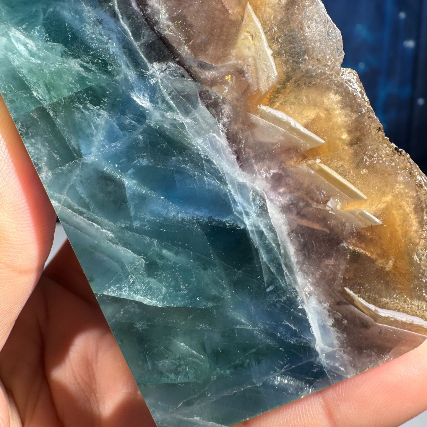 Rainbow Fluorite point with raw half