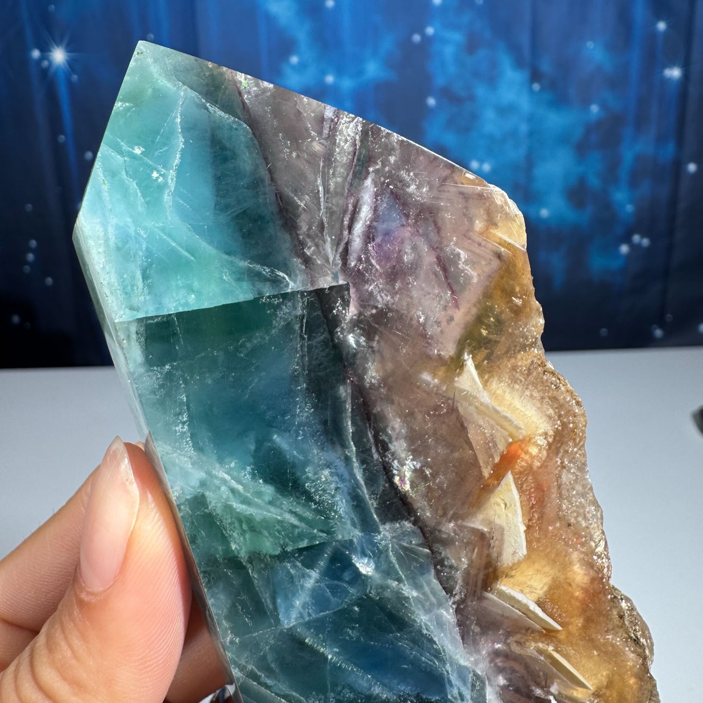 Rainbow Fluorite point with raw half