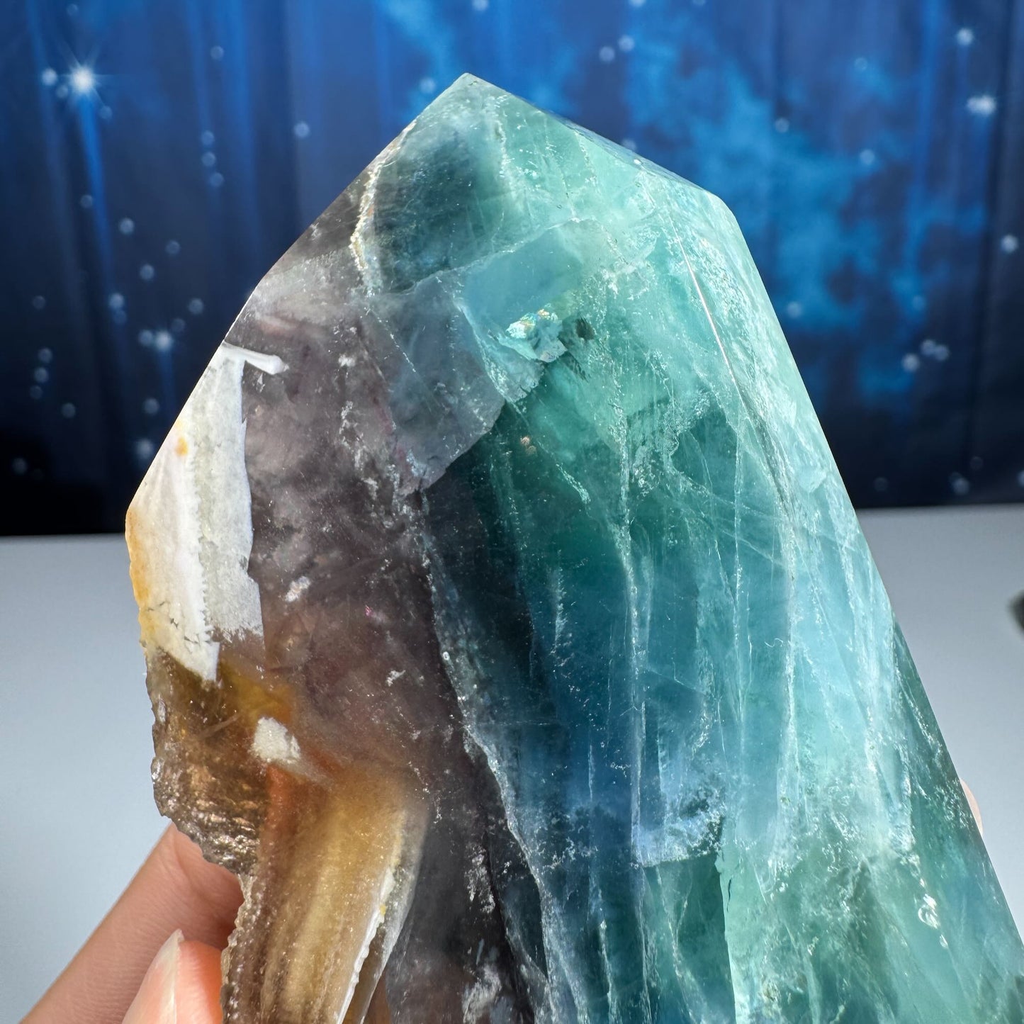Rainbow Fluorite point with raw half