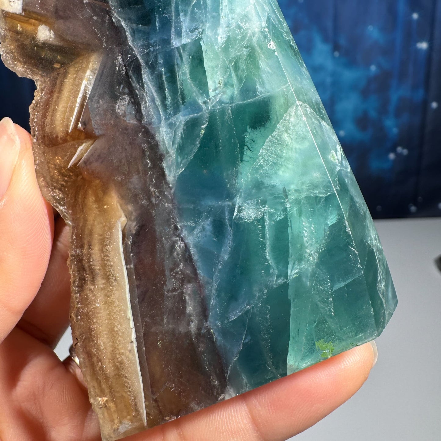 Rainbow Fluorite point with raw half