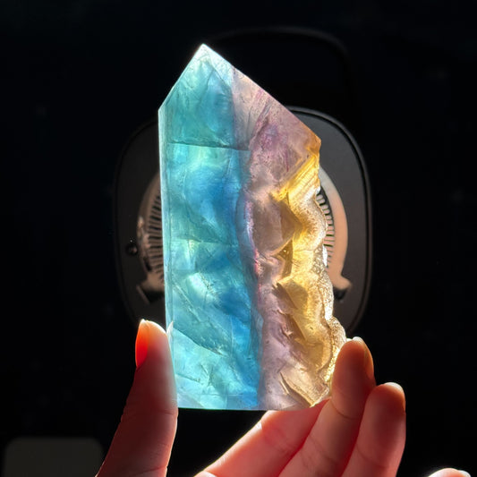 Rainbow Fluorite point with raw half