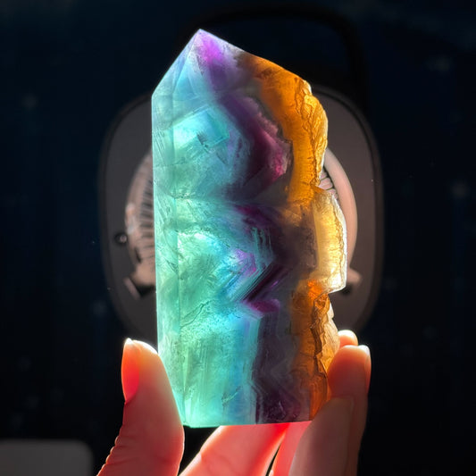 Rainbow Fluorite point with raw half