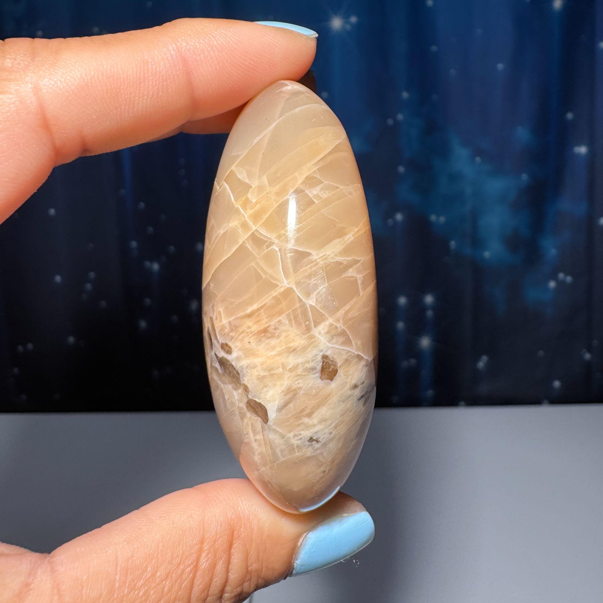Flashy Peach Moonstone palm stone | 2 5/8" long | 113 grams | dual flash | Sunstone inclusion | Smoky Quartz inclusion